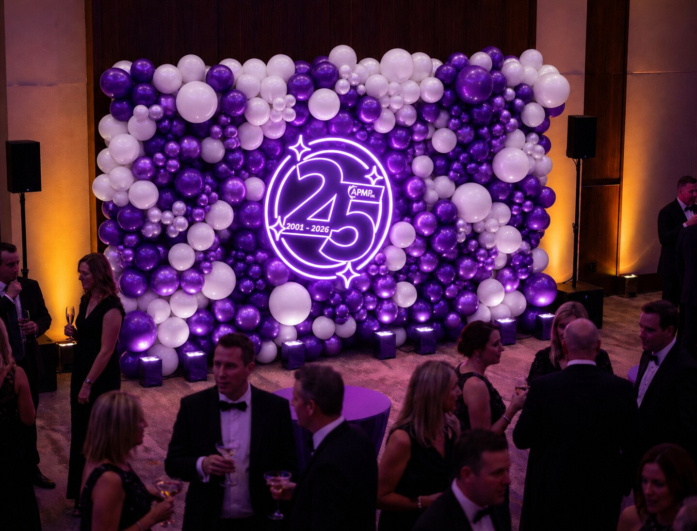 APM UK purple and white balloon wall backdrop