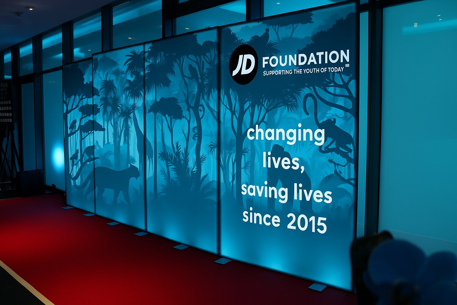 JD Foundation teal jungle-themed step and repeat wall