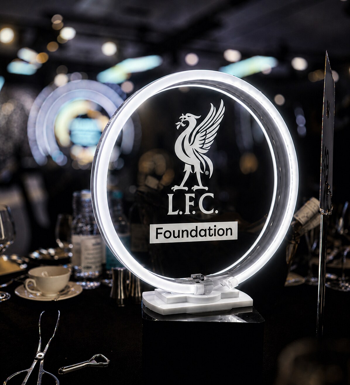 Illuminated LFC Foundation branded table centrepiece at a gala dinner